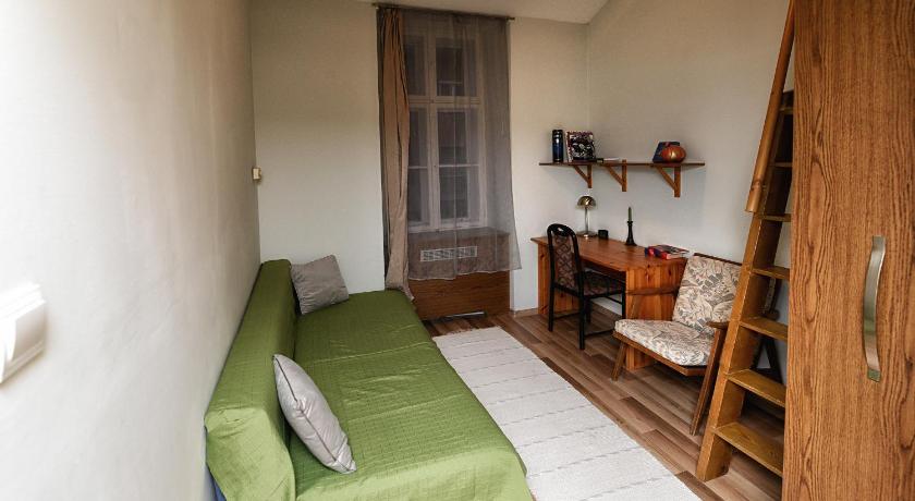 a bedroom with a bed and a desk, Centrum Apartman in Pecs