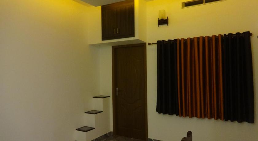 a bathroom with a toilet, sink, and shower stall, i - One's Home Stay in Kochi