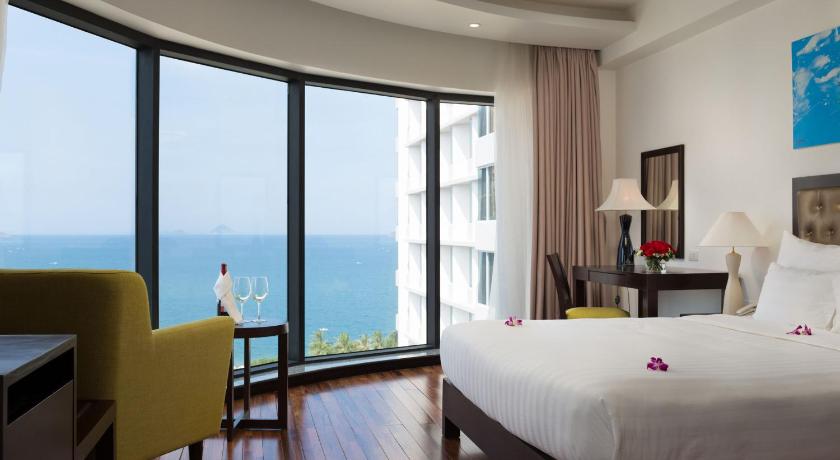 a hotel room with a large bed and a large window, LegendSea Hotel in Nha Trang