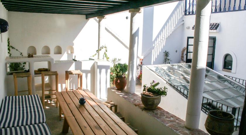 a patio area with a table and chairs, Riad Darbask in Essaouira