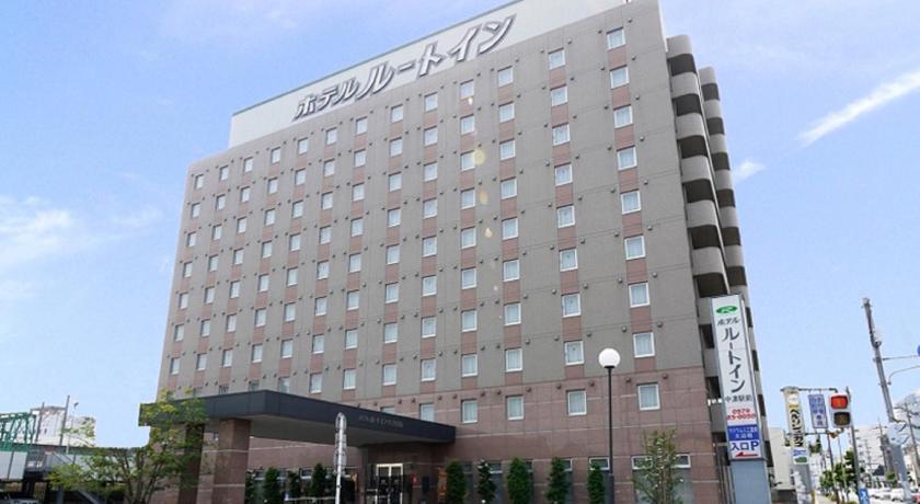 a large building with a large clock on the side of it, Hotel Route Inn Nakatsu Ekimae in Nakatsu