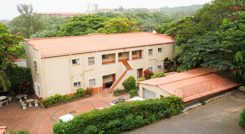 a large building with a large window, Doonside Holiday Apartments in Durban
