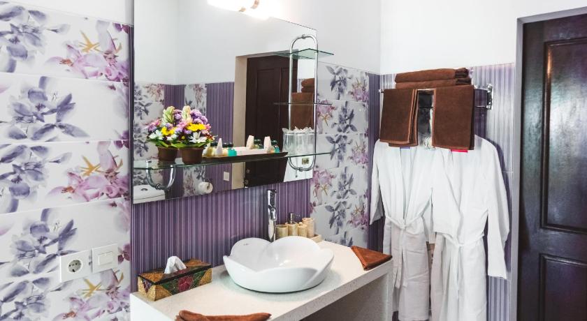 a bathroom with a sink and a mirror, Villa Gusmania in Bali
