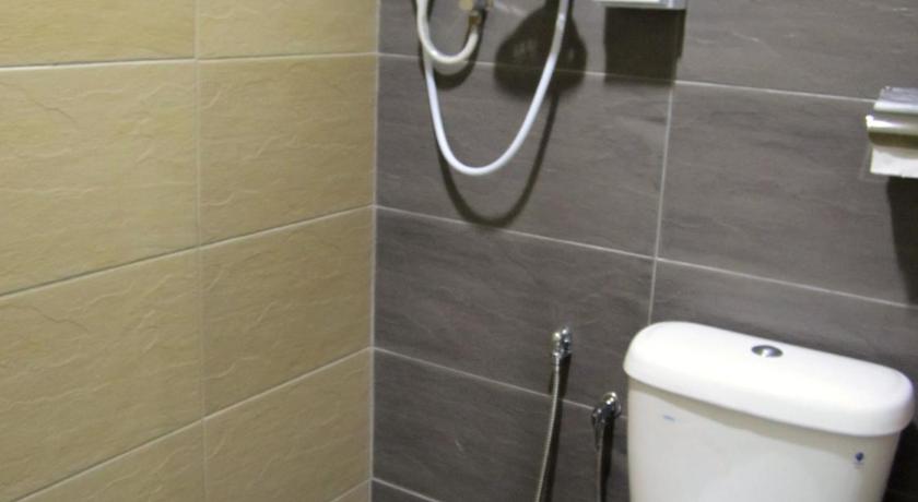 a bathroom with a toilet and a shower stall, Eco Hotel Putra Kajang in Kuala Lumpur