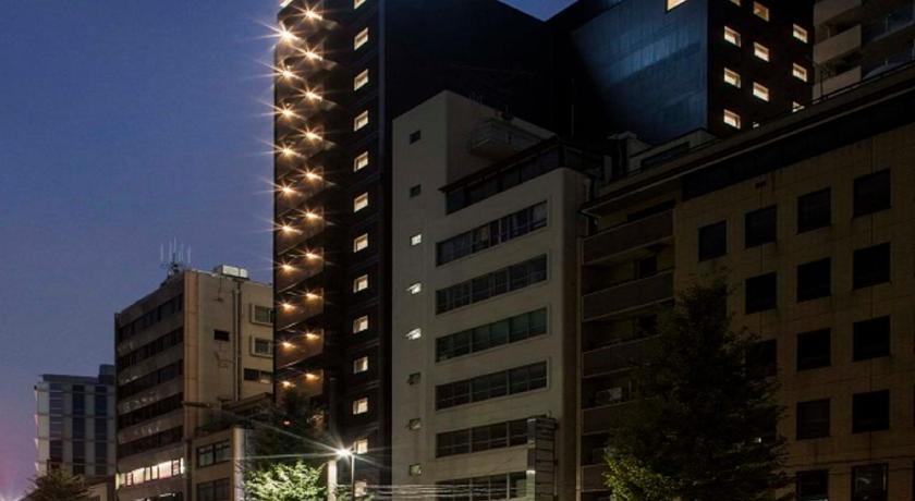 a city street with tall buildings and tall buildings, APA Hotel Ochanomizu-Ekikita in Tokyo