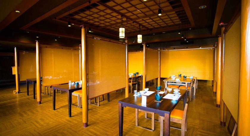 a room with a table, chairs, and tables in it, Hotel Sekitei in Yamanashi