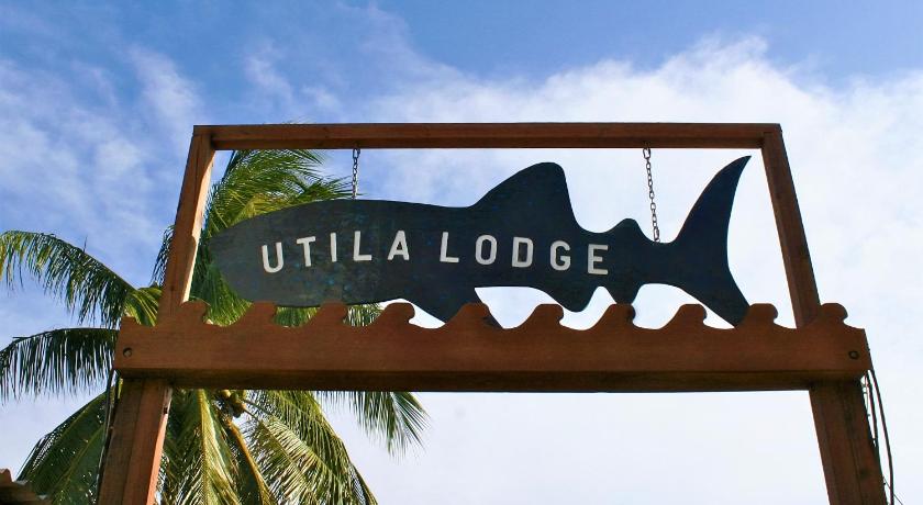 a sign that is on the side of a building, Utila Lodge in Utila