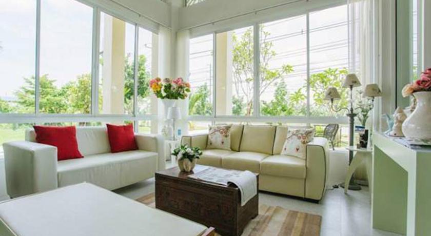 a living room filled with furniture and a window, The Terrace Hotel in Nakhon Si Thammarat