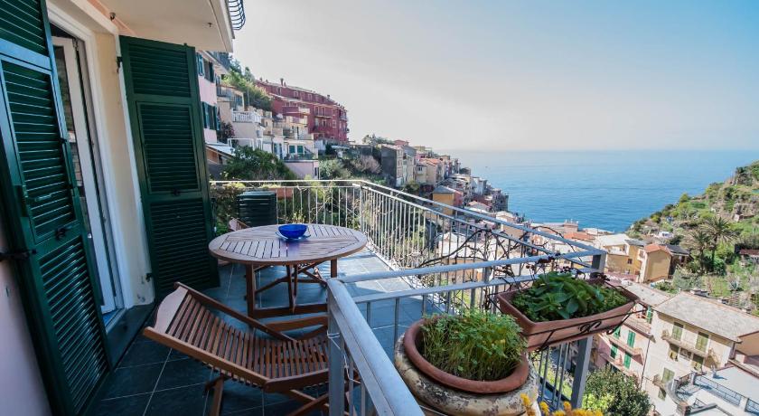 a patio area with a patio table and chairs, Luxury Seaview Apartments Manarola by Arbaspaa in Riomaggiore