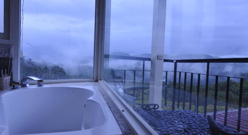 a white bath tub sitting in front of a window, View on View B & B in Nantou