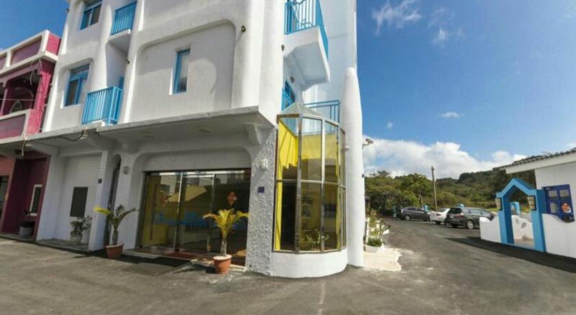 a man is standing outside of a building, Shen’s Village Hotel Cozy in Kenting