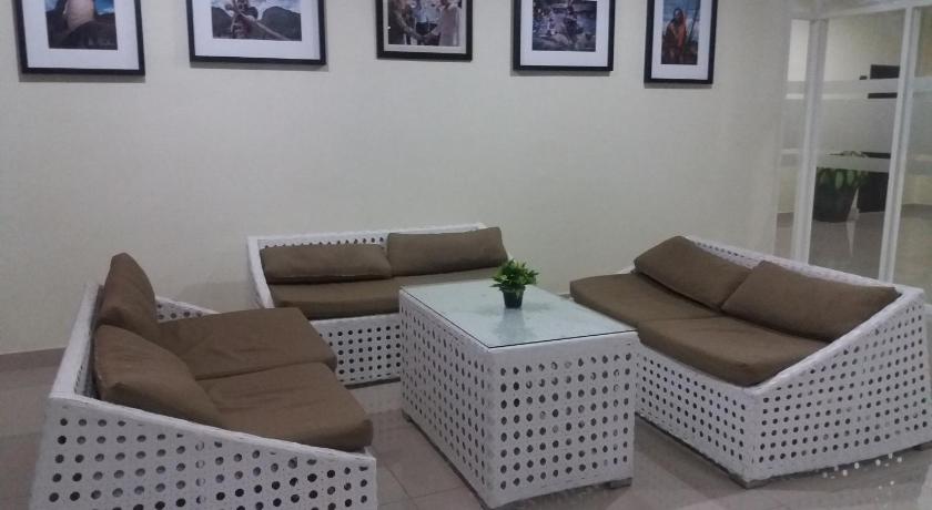a living room filled with furniture and a couch, AVON'S RESIDENCE in Manado