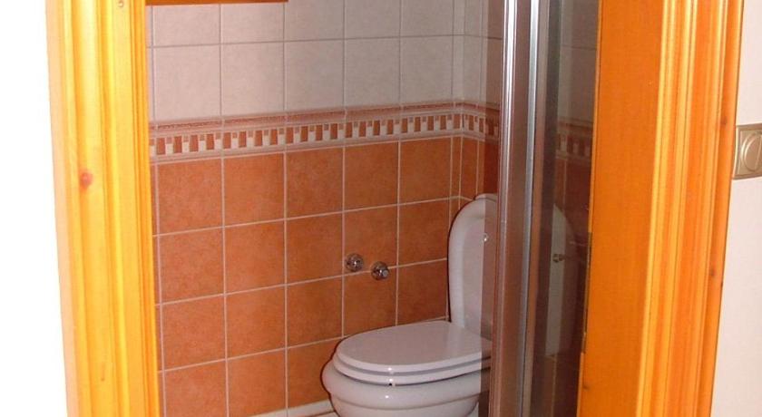a bathroom with a toilet a sink and a shower, Bruckner Villa Apartman in Balatonfured