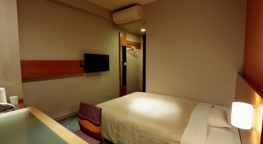 a hotel room with a bed and a television, Candeo Hotels Sano in Sano