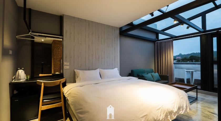 a bedroom with a large bed and a large window, Manman Art bnb in Hualien