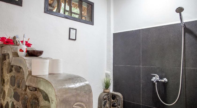 a bath room with a shower and a toilet, EcoTravel Cottages Bukit Lawang in Bukit Lawang