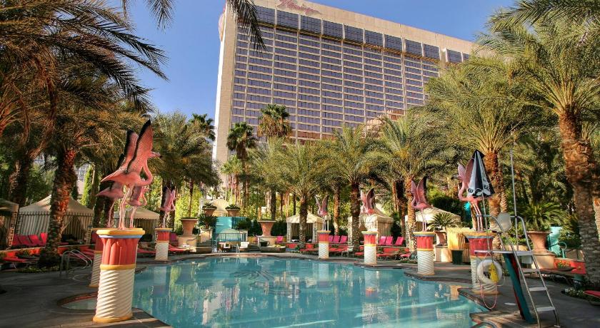 a large swimming pool surrounded by palm trees, Flamingo Las Vegas in Las Vegas (NV)