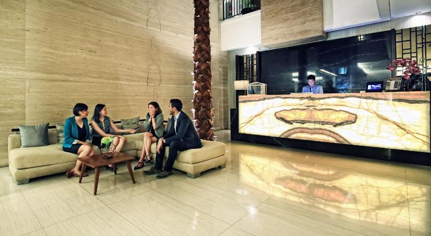 people sitting on couches in a living room, Rasuna Icon Hotel in Jakarta