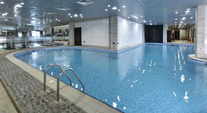 a large swimming pool in a large building, Awaliv International Hotel in Al Taif