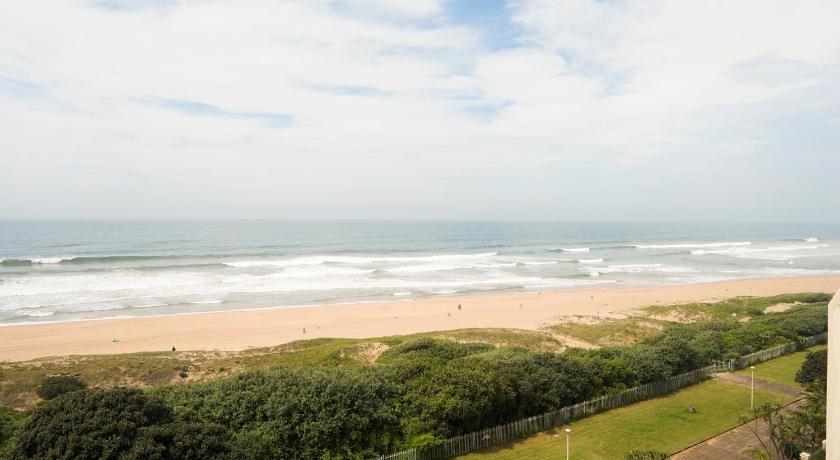 a sandy beach with a view of the ocean, Beachfront Apartments @ Amanzimtoti in Durban