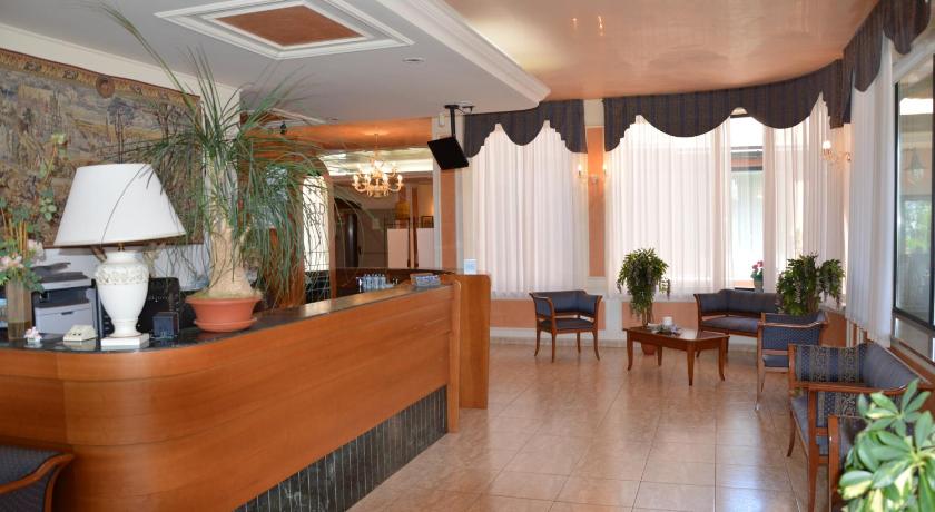 a living room filled with furniture and a large window, Hotel Rosamarina in San Giovanni Rotondo