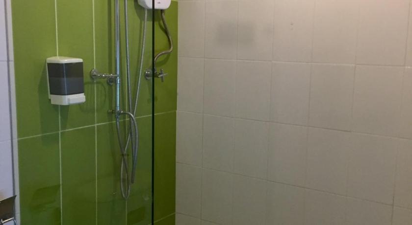 a bathroom with a shower stall and a shower curtain, Shanghai Guesthouse in Pattaya
