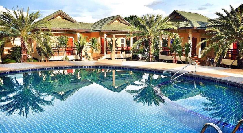a large swimming pool in a tropical setting, Huan Soontaree Resort in Rayong
