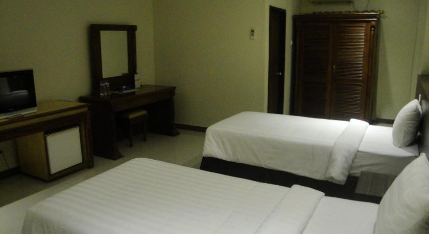 a hotel room with two beds and a television, Sylvia Hotel Budget Kupang in Kupang