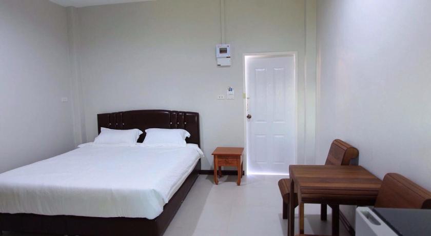 a bedroom with a bed and a desk, Nava Resort in Nakhon Nayok