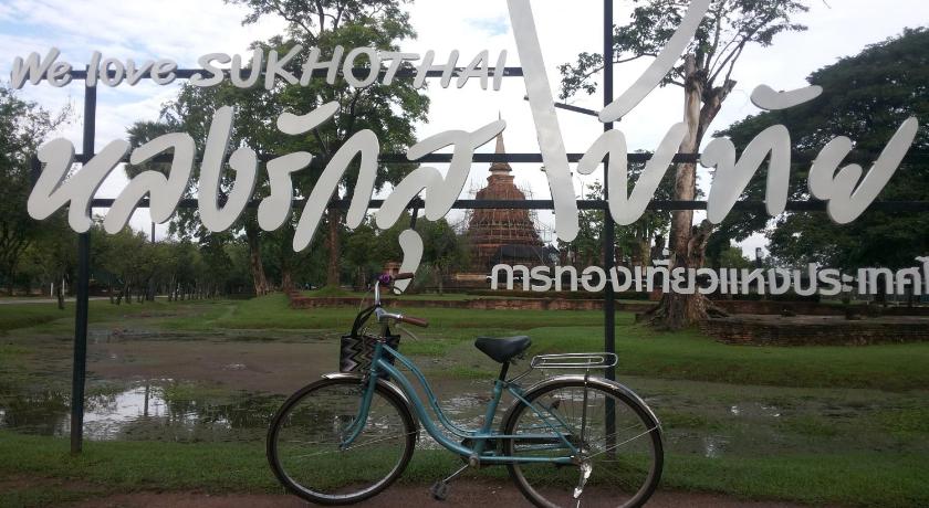 a bicycle parked in front of a fire hydrant, VitoonGuesthouse2Fanroom in Sukhothai