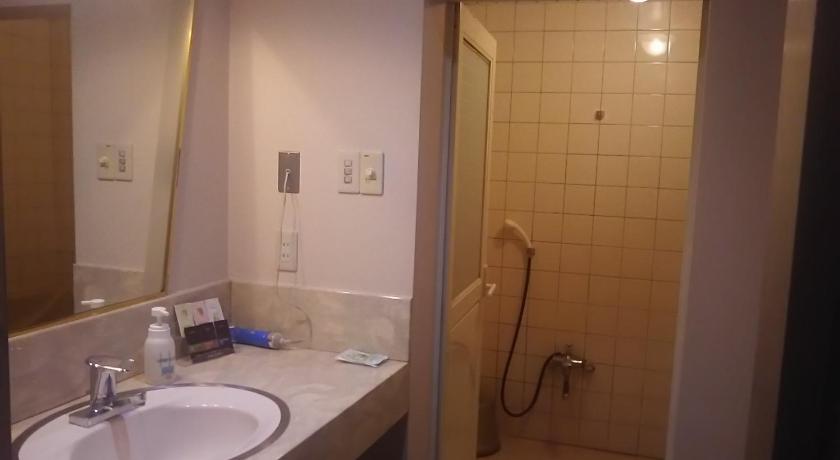 a bathroom with a sink, mirror, and bathtub, Hotel Sting in Tokyo