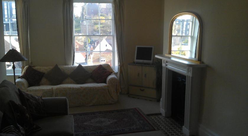 a living room filled with furniture and a window, Teesdale Rooms in Whitby