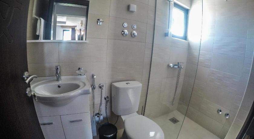 a bathroom with a toilet a sink and a mirror, Apartments Timoni in Ulcinj