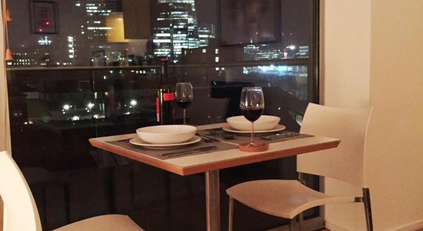 a table with a laptop on top of it, The Maltings Tower Bridge Apartment in London