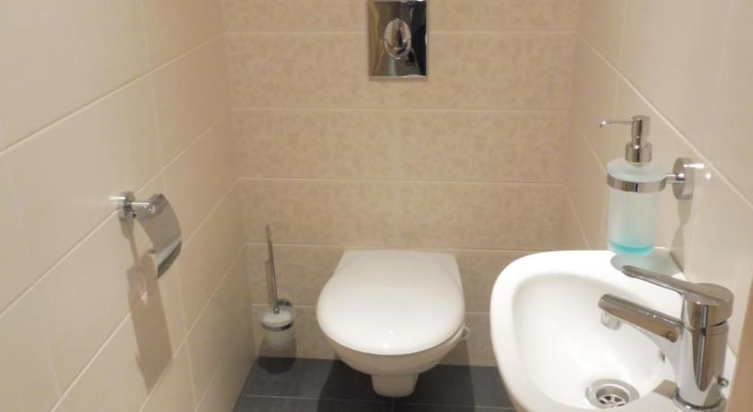 a bathroom with a toilet and a sink, Azur Apartman in Velence
