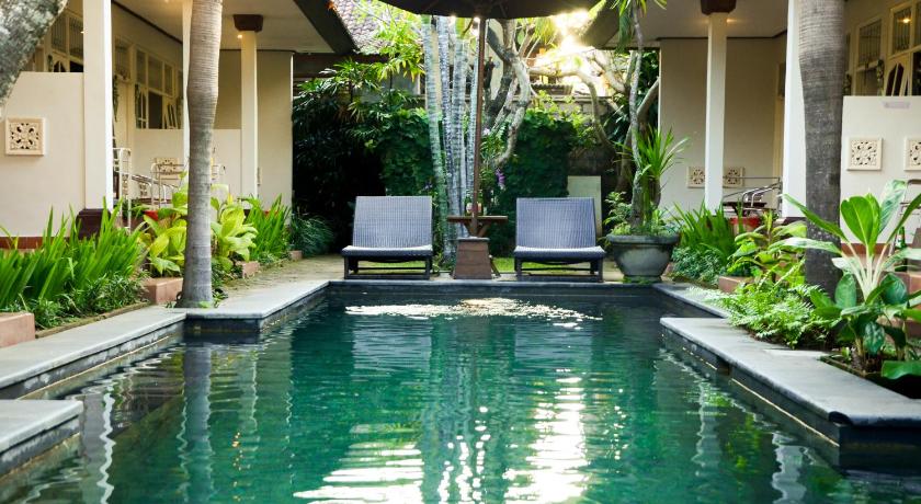 a pool of water with a chair in front of it, Little Pond Homestay in Bali