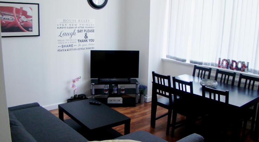 a living room filled with furniture and a tv, Corporation Street Apartment in Manchester
