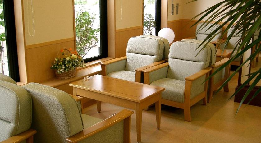 a living room filled with furniture and a table, Hotel Route Inn Yokote Inter in Yuzawa-shi