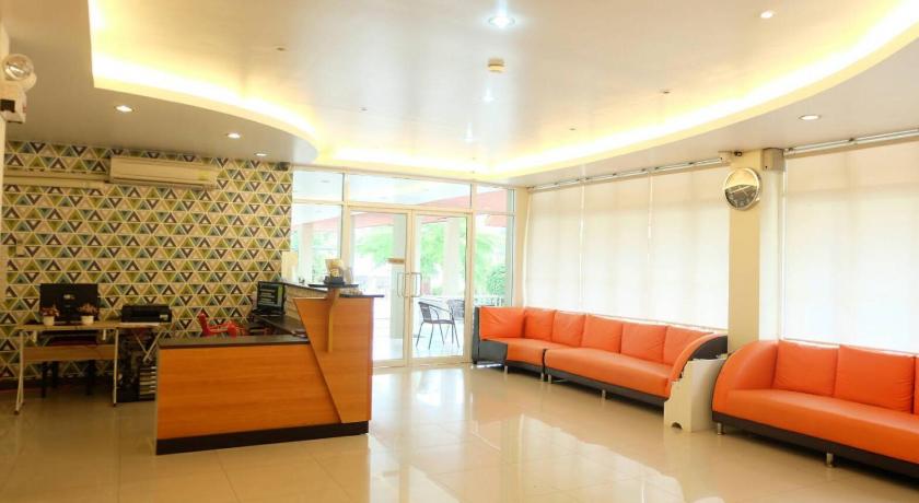 a living room filled with furniture and a large window, Better Place Hotel in Ubon Ratchathani