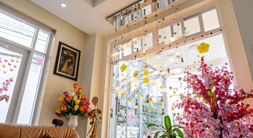 a living room filled with furniture and flowers, Minh Nhan Hotel in Vung Tau