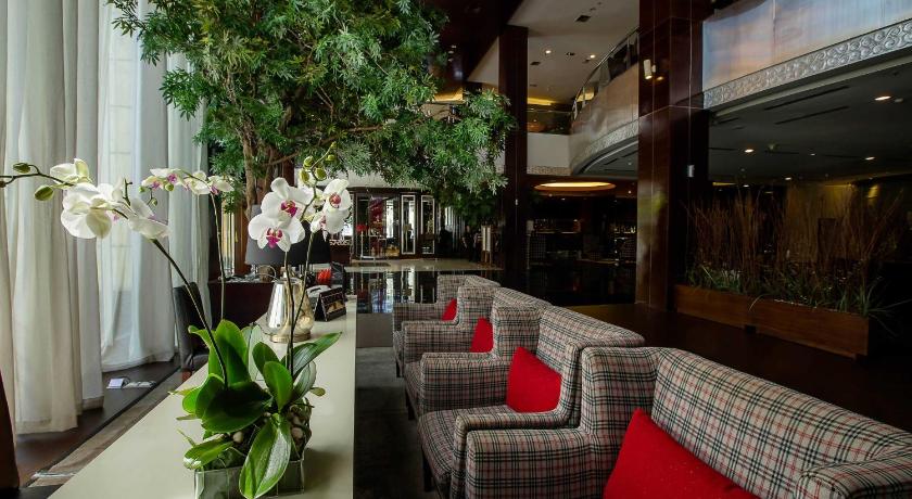 a living room filled with furniture and flowers, The Arista Hotel Palembang in Palembang