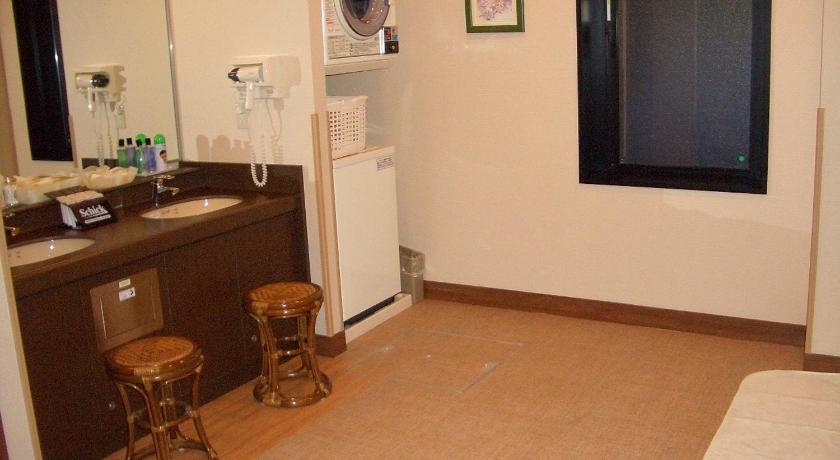a kitchen with a refrigerator, sink and a television, Hotel Route Inn Aomori Chuo Inter in Aomori