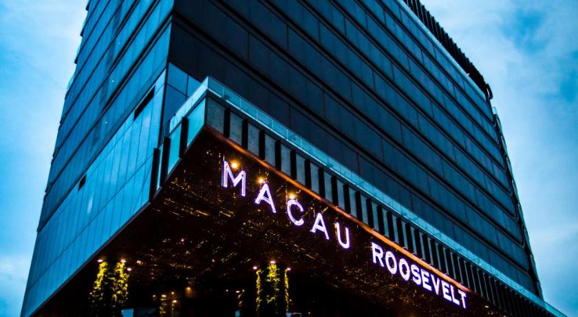 a large building with a sign on the side of it, The Macau Roosevelt in Macau