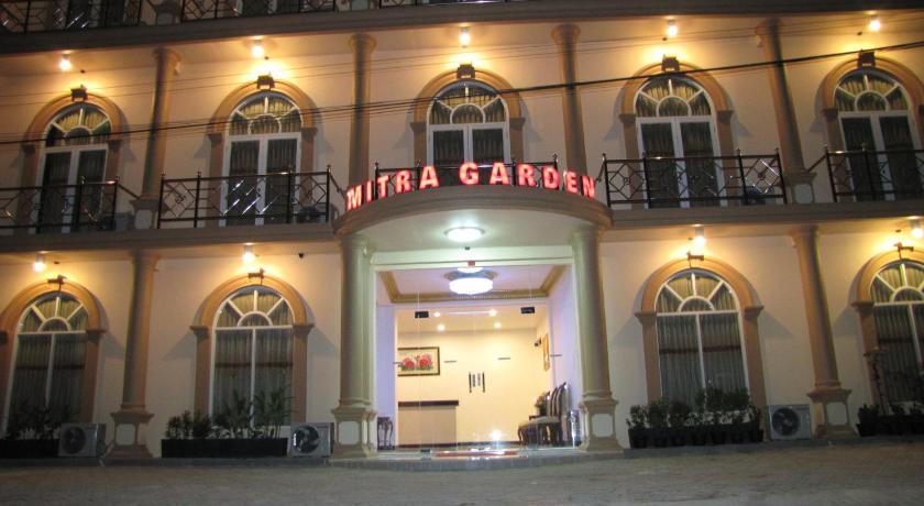 a large building with a clock on the front of it, Mitra Garden Hotel in Bangka