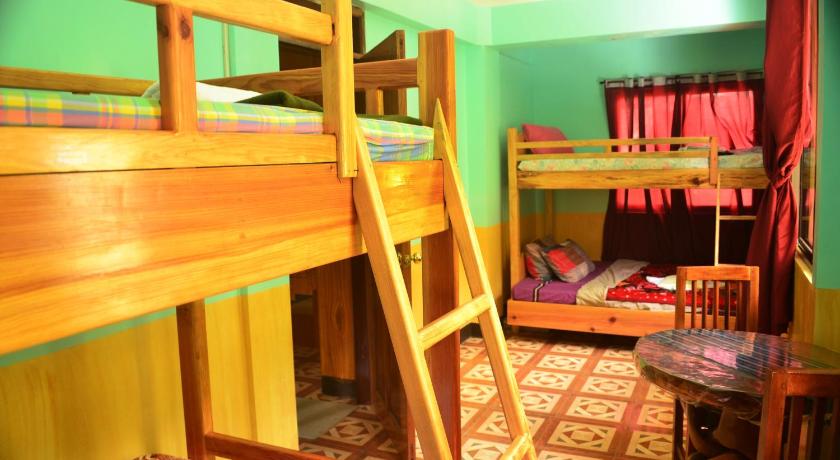 a bedroom with a bunk bed and a desk, Banaue Greenfield Inn and Restaurant in Banaue