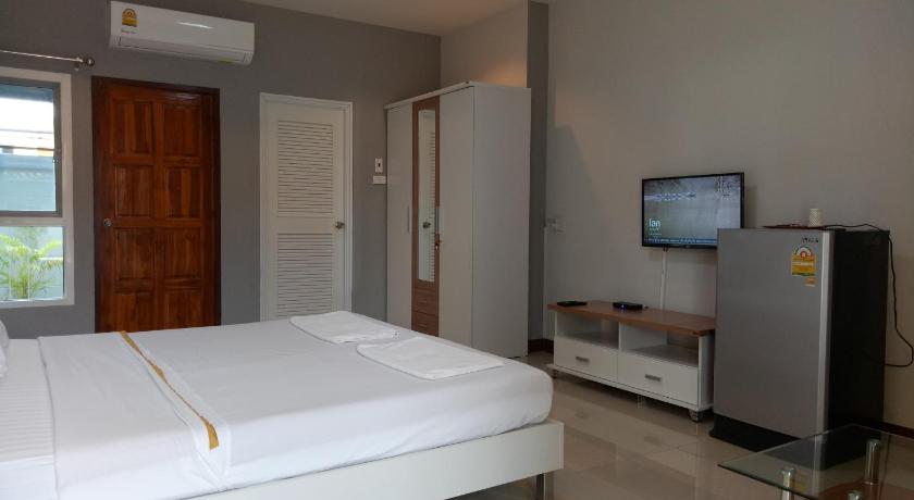 a hotel room with a television and a bed, Dowrung Place in Phetchaburi