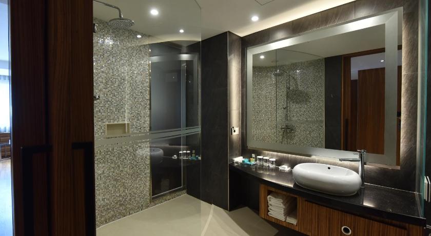 a bathroom with a shower, sink, and mirror, Pacific Hotel in Seoul