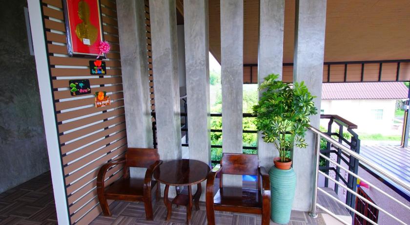a patio area with chairs, a table and a table cloth, Nava Resort in Nakhon Nayok