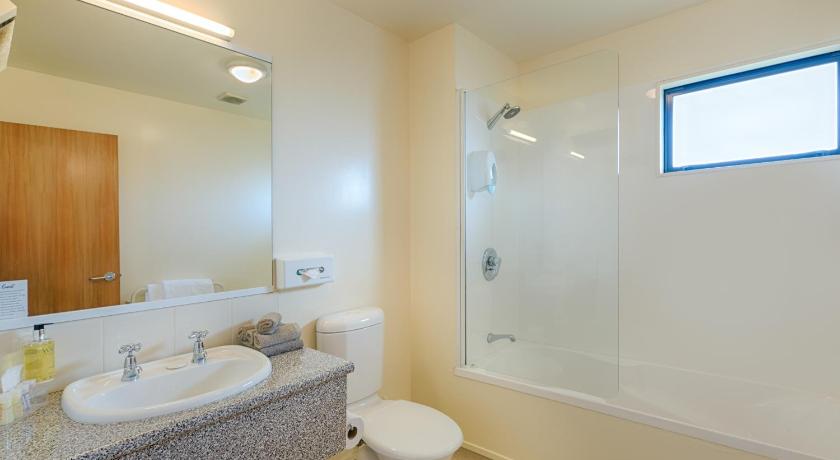 a bathroom with a toilet, sink, and shower, Bella Vista Motel Palmerston North in Palmerston North