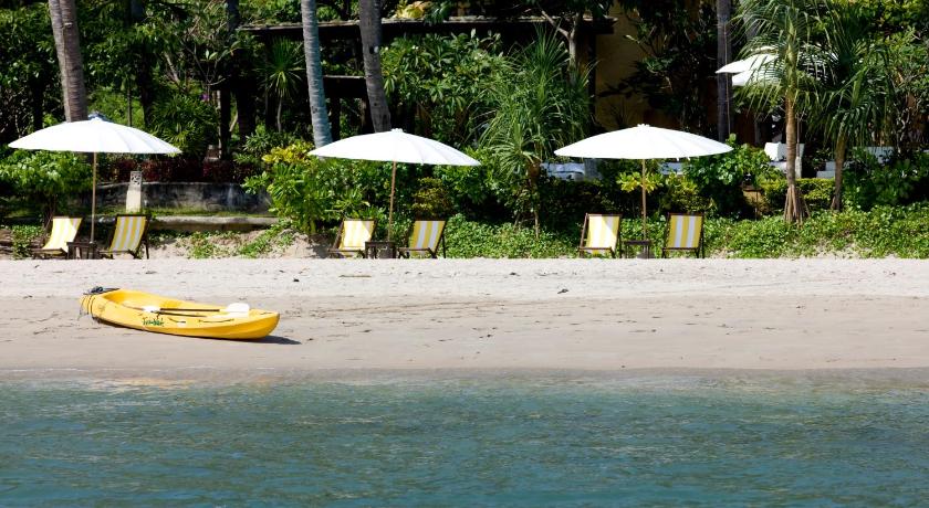 a yellow surfboard sitting on top of a sandy beach, Vacation Village Phra Nang Lanta (SHA Extra Plus) in Koh Lanta